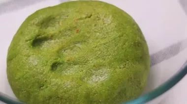 Pistachio modaks drizzled with melted chocolate on a festive plate 2